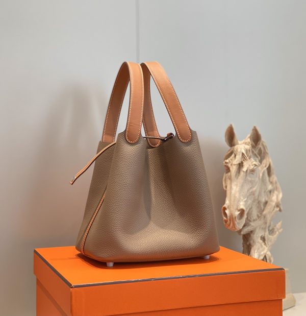 The elephant is grey/golden brown - Image 3